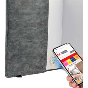 A grey felt notebook with a plain cover, alongside a smartphone displaying a website.