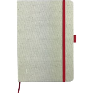 A cream-coloured A5 cotton notebook with a red elastic band and bookmark. Features a logo on the cover.