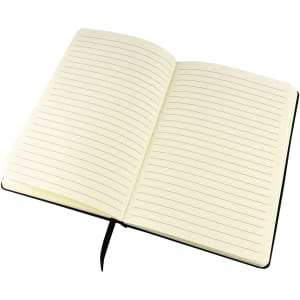 An open Finch Notebook with lined pages and a black cover, featuring a ribbon bookmark.
