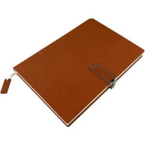 A brown notebook with a textured cover, featuring a metal clip and bookmark. It has branding on the front.