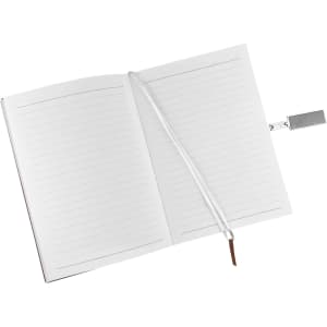 An open notebook with lined pages, featuring a ribbon bookmark and a silver pen. The notebook has a logo on the cover.