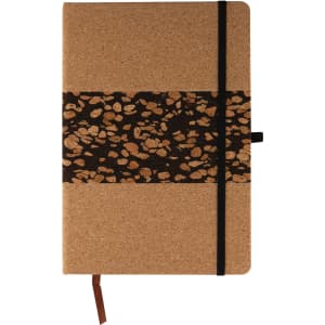A notebook with a cork cover and a decorative band featuring coffee grounds patterns, secured with a black elastic.