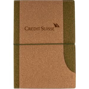 A cork notebook with a green accent and an elastic strap, featuring a logo on the cover.