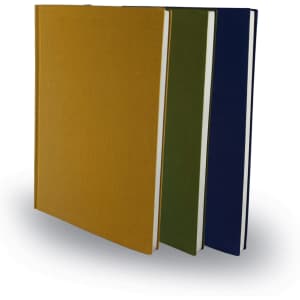 A set of three A5 notebooks in mustard, olive green, and navy blue, featuring a smooth cover and a minimalist design.