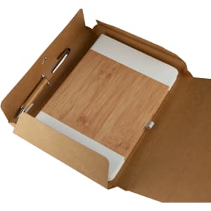 A cardboard gift box containing a bamboo notebook and a pen, all in natural tones.