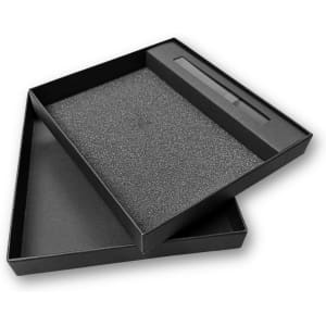 A black notebook gift set box with a foam insert and a sleeve for a pen, featuring a logo.
