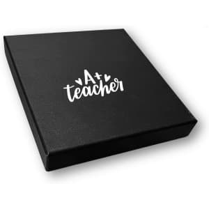 A black gift box with a logo on the top, designed for a notebook gift set.