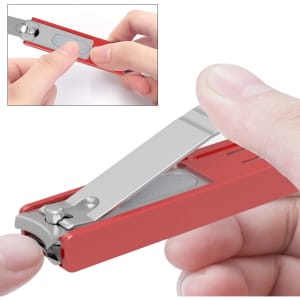 A red nail clipper with a stainless steel blade and a keyring attachment, being held by a person's hand.