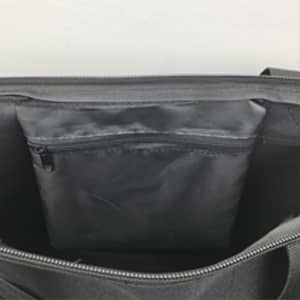 A grey nylon tote bag with a zipped interior pocket and a spacious main compartment.