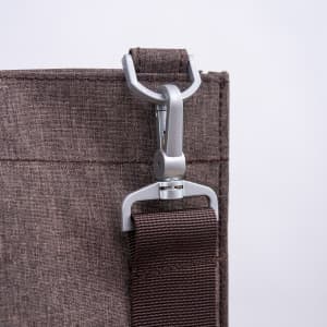A grey nylon library bag featuring a clasp attachment and a sturdy strap for convenience.