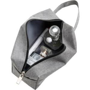 A grey nylon cosmetic bag unzipped, revealing perfume bottles and a pen inside. It features a handle and logo.