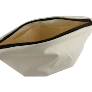A large cream cosmetic bag with a black zipper, featuring a spacious interior. It includes a logo on the exterior.