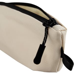 A small cream-coloured cosmetic bag with a black zipper and a zipper pull, featuring a sturdy design.
