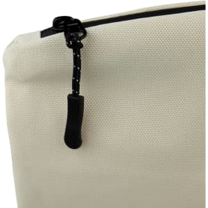 A small cosmetic bag in cream colour with a black zipper and a textured fabric appearance. Features a logo.