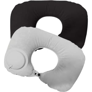 Two inflatable neck pillows in black and white, featuring a circular valve and a smooth texture.