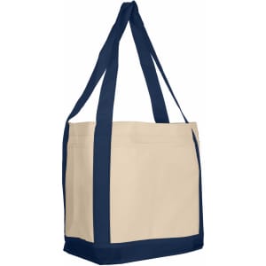 A large reusable grocery bag in cream with navy blue straps and trim, featuring a logo on the side.