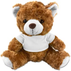 A plush teddy bear in a soft brown colour, wearing a plain white t-shirt, with black button-like eyes.