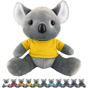 A grey koala plush toy wearing a yellow shirt, featuring black eyes and ears. It sits among smaller koala toys in various colours.