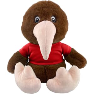 A brown kiwi plush toy wearing a red shirt, featuring large eyes and a distinct beak. It has pink feet and a soft texture.