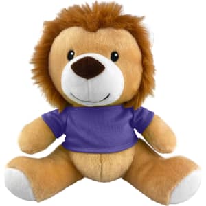 A plush lion toy with a tan body and a brown mane, wearing a purple shirt. It has a friendly smiling face.