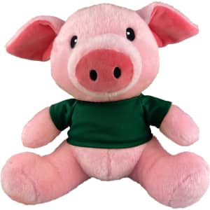 A pink plush pig with a green T-shirt, featuring black eyes and a large snout. It has a branding logo on the shirt.