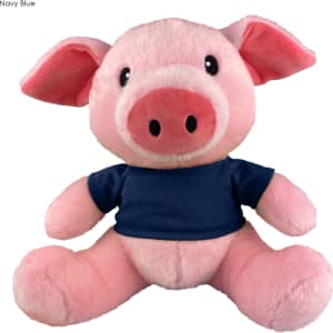 A cute pink pig plush toy wearing a navy blue shirt, with large ears and a friendly expression. It has a logo on it.