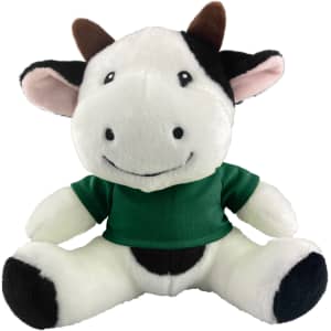 A plush cow toy featuring black and white fur with a green shirt, smiling with ear and horn details.