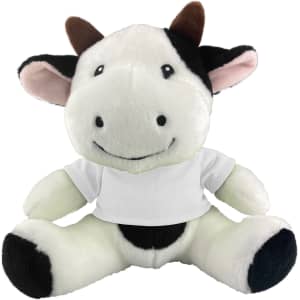 A plush cow toy featuring black and white fur, with a smiling face and a white shirt. It has a soft, cuddly appearance.