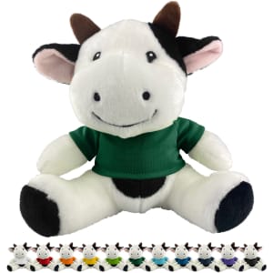 A plush cow toy in black and white with a green shirt, featuring a friendly smile and small horns.