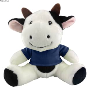 A soft, plush cow toy in black and white, wearing a navy blue shirt. It has a cheerful expression.