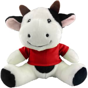 A plush cow toy with black and white fur, wearing a red shirt and featuring a smiling face.