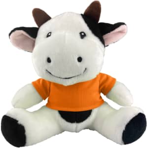 A plush cow toy with black and white fur, wearing an orange shirt, featuring a friendly smile and brown horns.