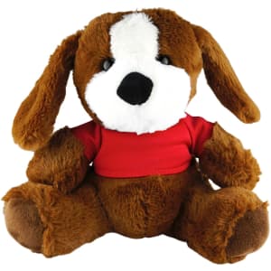 A brown plush dog with floppy ears wearing a red shirt, seated and looking forward. It has a soft, fluffy texture.