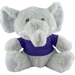 A grey plush elephant with large ears, wearing a purple t-shirt, sitting upright. It has a logo on the shirt.