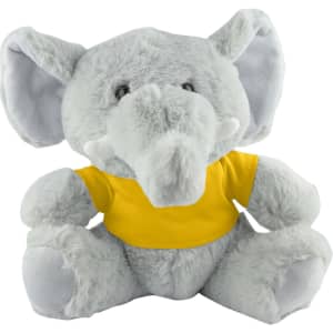 A grey plush elephant wearing a yellow T-shirt, with large ears and a friendly expression.