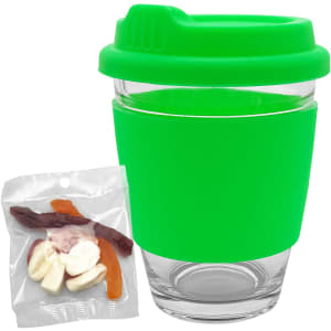 A green Carlo glass coffee cup with a silicone sleeve, alongside a bag of assorted jelly sweets.
