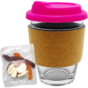 A glass coffee cup with a pink lid and cork band, accompanied by a pack of mixed lollies in various colours.