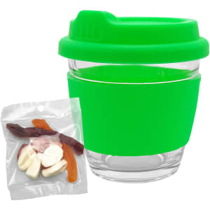 A green Venice glass coffee cup with a matching lid, accompanied by a pack of mixed lollies in various colours.