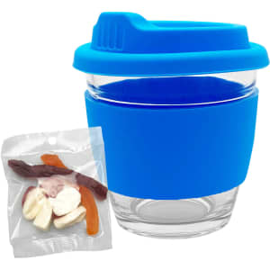 A glass coffee cup with a blue silicone lid and sleeve, paired with a packet of mixed jelly lollies.