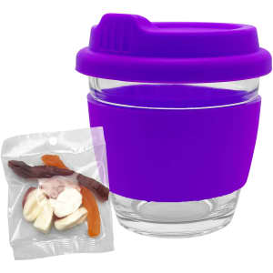 A purple Venice glass coffee cup with a silicone sleeve, accompanied by a pack of assorted mixed lollies.