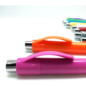 A set of plastic pens in various colours, featuring an orange and pink pen in the foreground. Each pen has a clip and silver accents.