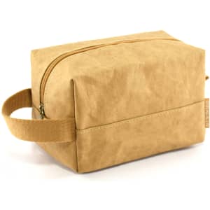 A kraft paper cosmetic bag in a tan colour with a zip closure and a side handle. It has a simple, modern design.