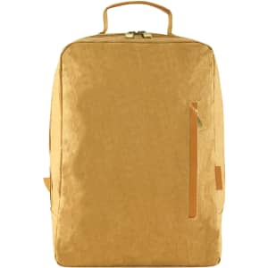 A yellow kraft paper laptop backpack with a top handle and a side zip pocket. It features a minimalist design and a logo.