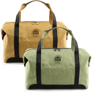 Two kraft paper travel bags in tan and green, featuring sturdy black handles and a branding logo.