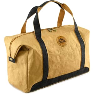 A tan kraft paper travel bag with black accents and handles, featuring a logo on the front.