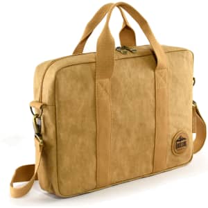 A tan kraft paper satchel with sturdy handles, a removable shoulder strap, and a logo patch.