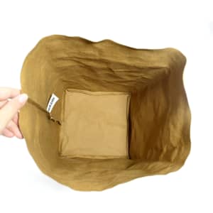 A large, brown Kraft paper storage bag with a soft, textured finish and an interior compartment.
