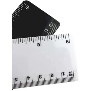 A plastic ruler set featuring a 15cm white ruler with black markings and a black ruler with white markings.