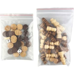 A clear bag containing various wooden game pieces, including brown and beige tokens, dice, and chess-like figures.