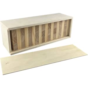 A large Jenga set comprising wooden blocks stacked within a rectangular box. The box is light-coloured wood.